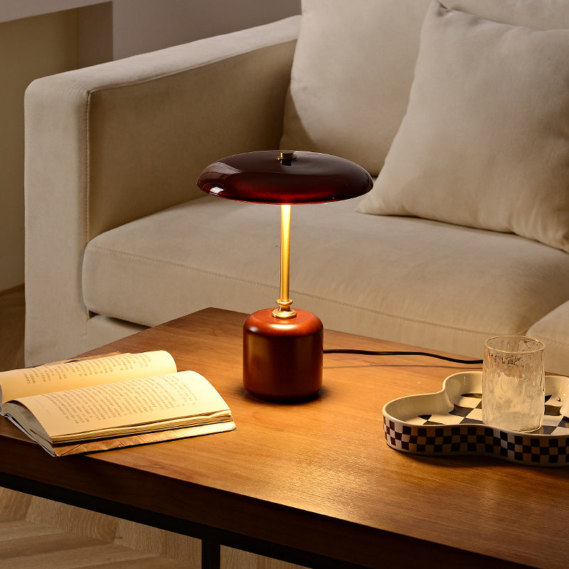 American MCM table lamp on a wooden table with a book and glass in a cozy living room setting.