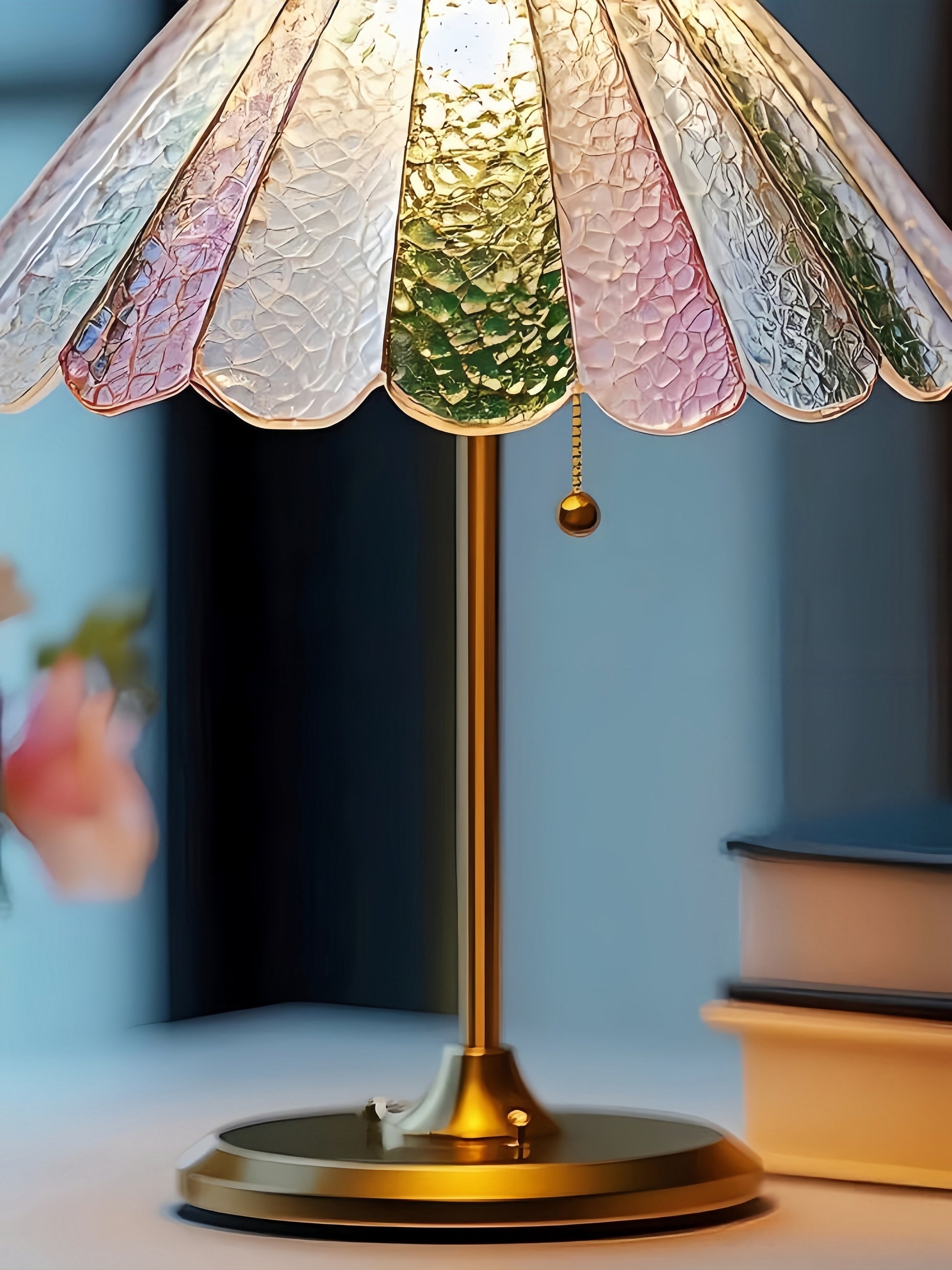Decorative colorful table lamp with a colorful glass shade on a blurred background