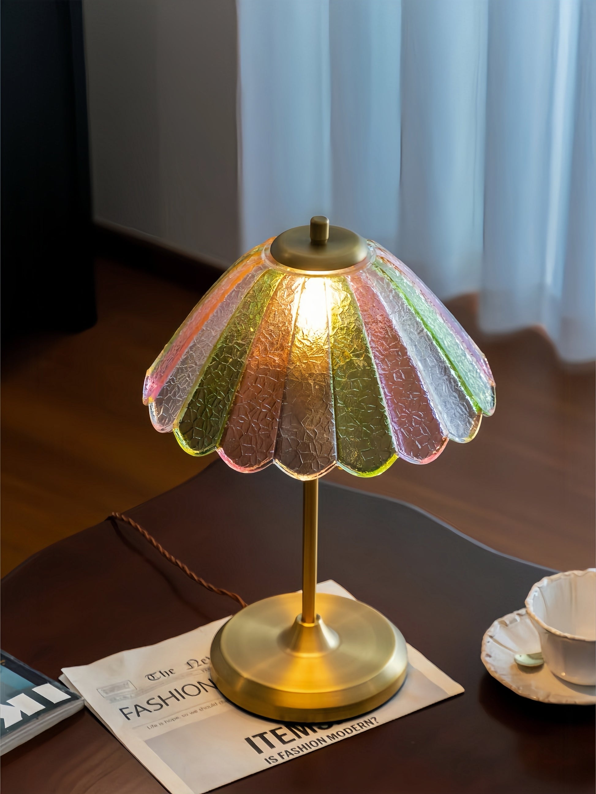 Decorative colorful table lamp with a colorful glass shade on a wooden surface.