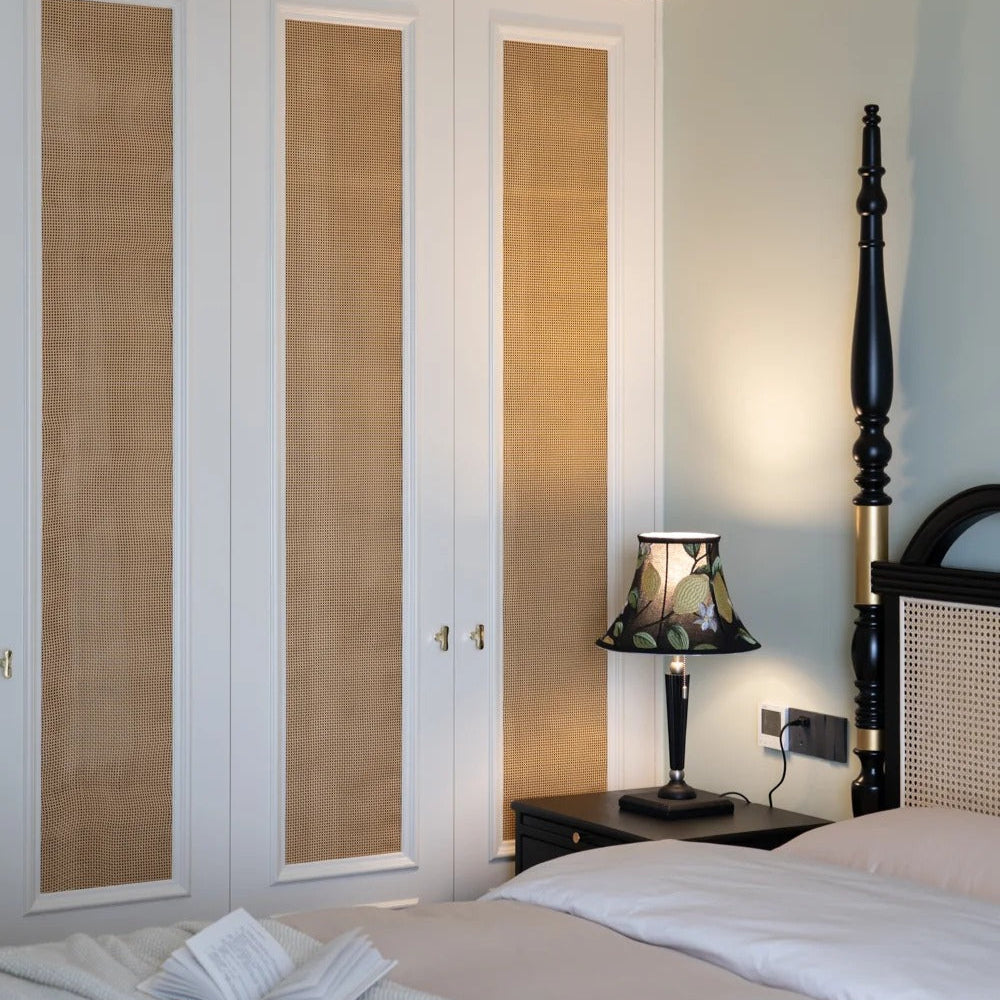 Side profile view showing black embroidery French table lamp as reading light in bedroom