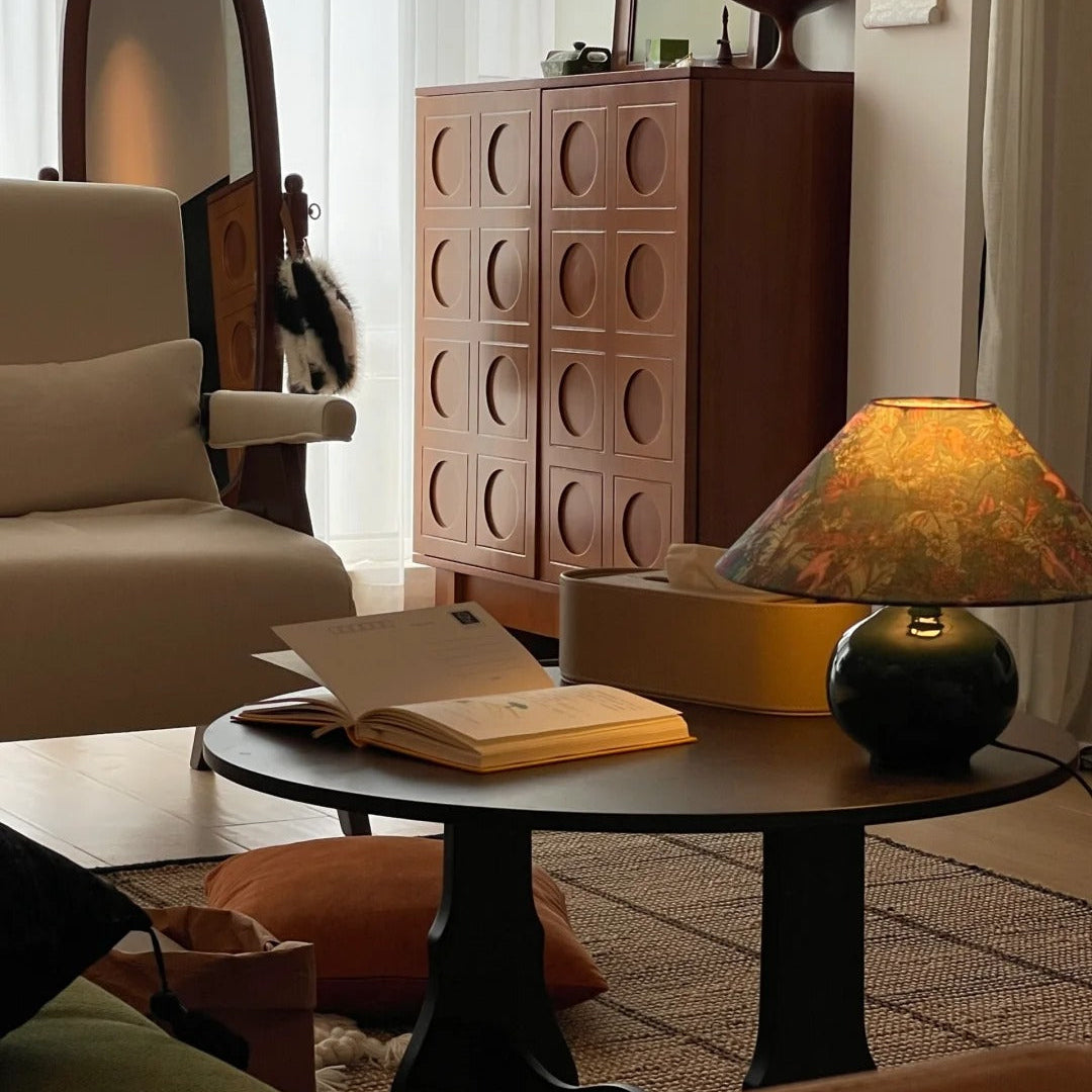 Front view of illuminated retro desk lamp casting warm ambient light in dim living room settings