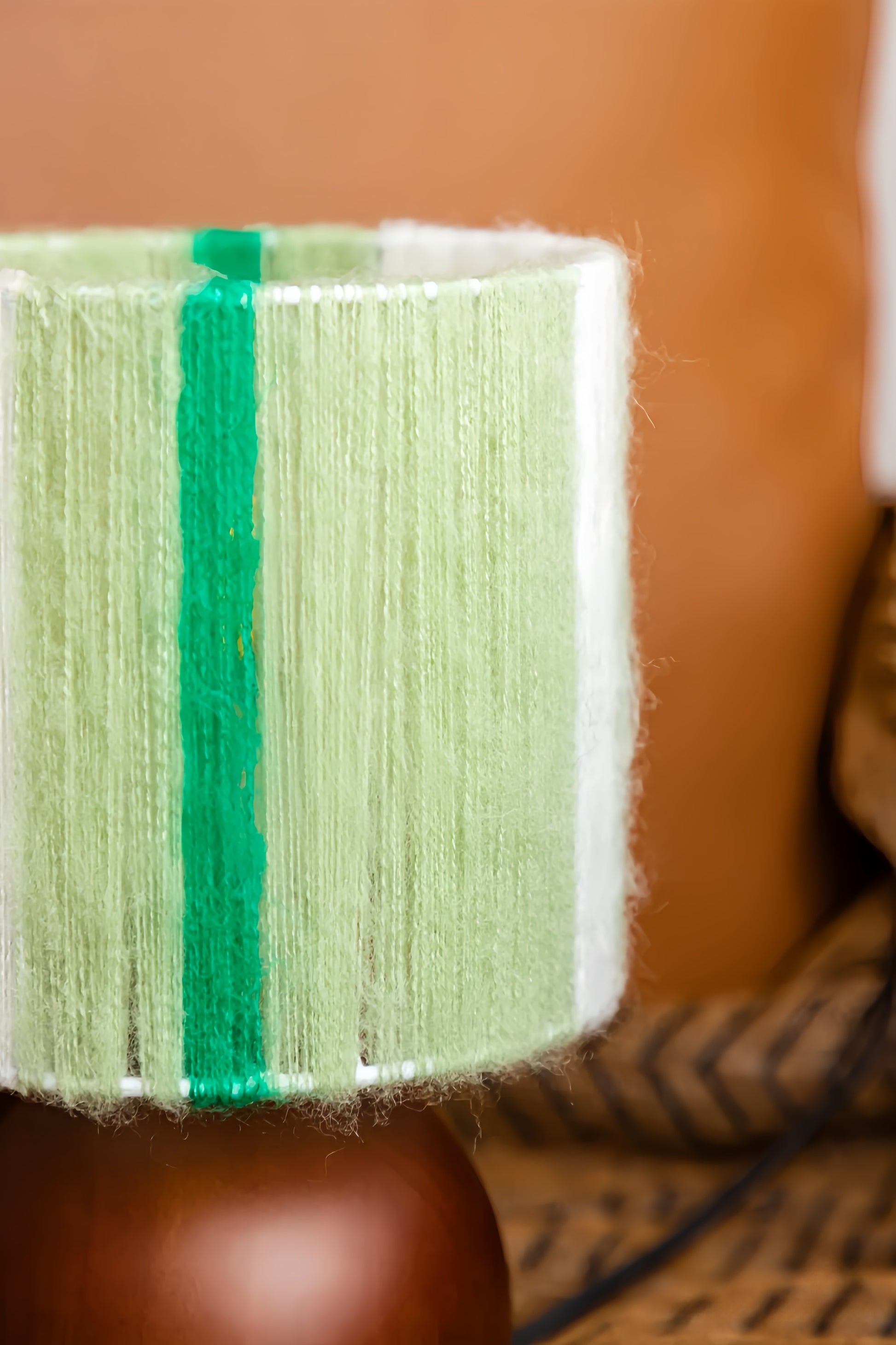 Close-up of a green and white striped fabric with a blurred background