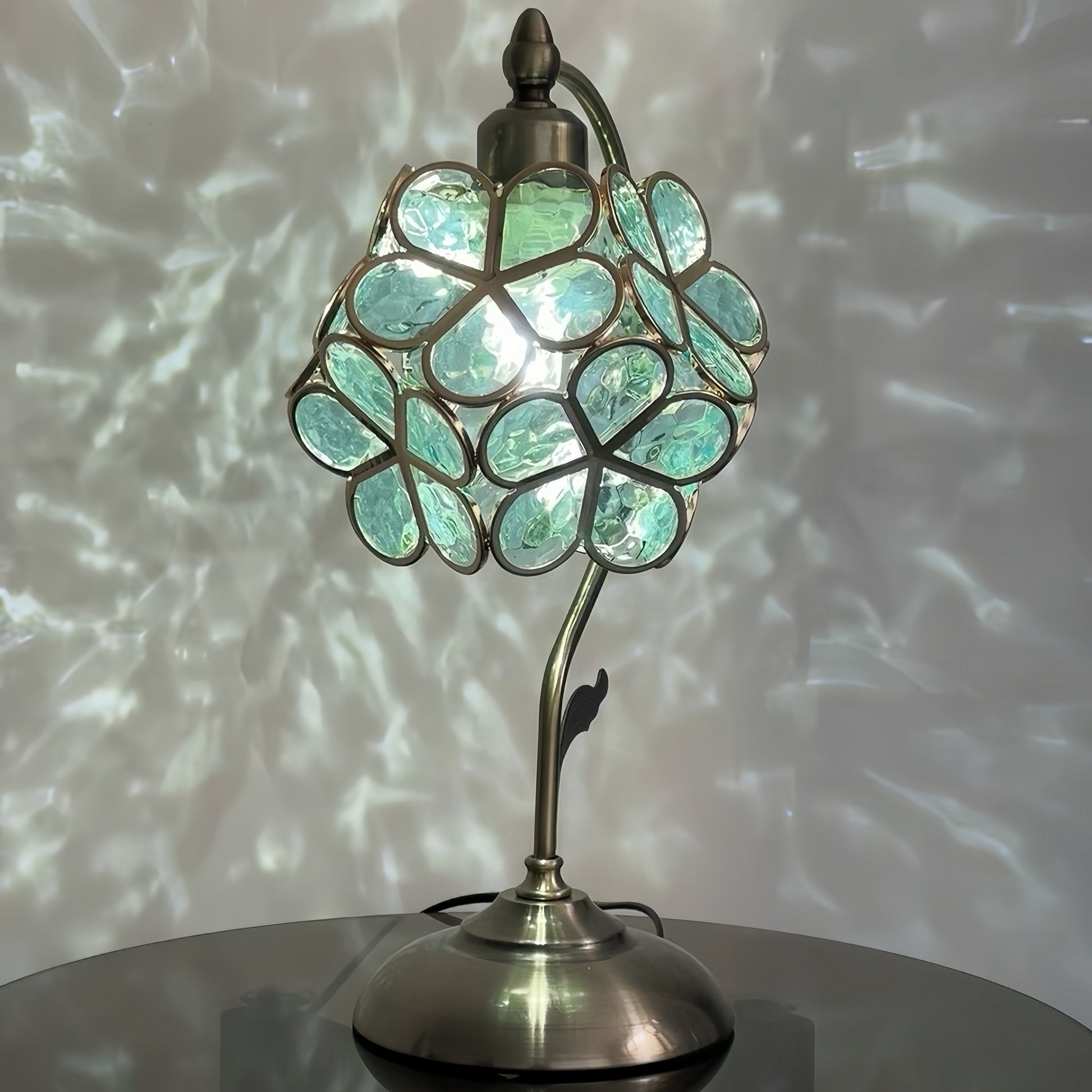 French decorative lamp with a floral design on a reflective surface