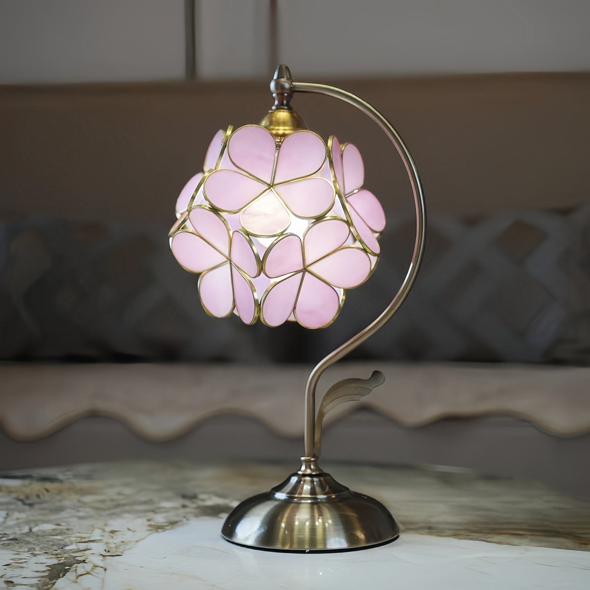 Pink floral MCM lamp on a marble surface with a blurred background