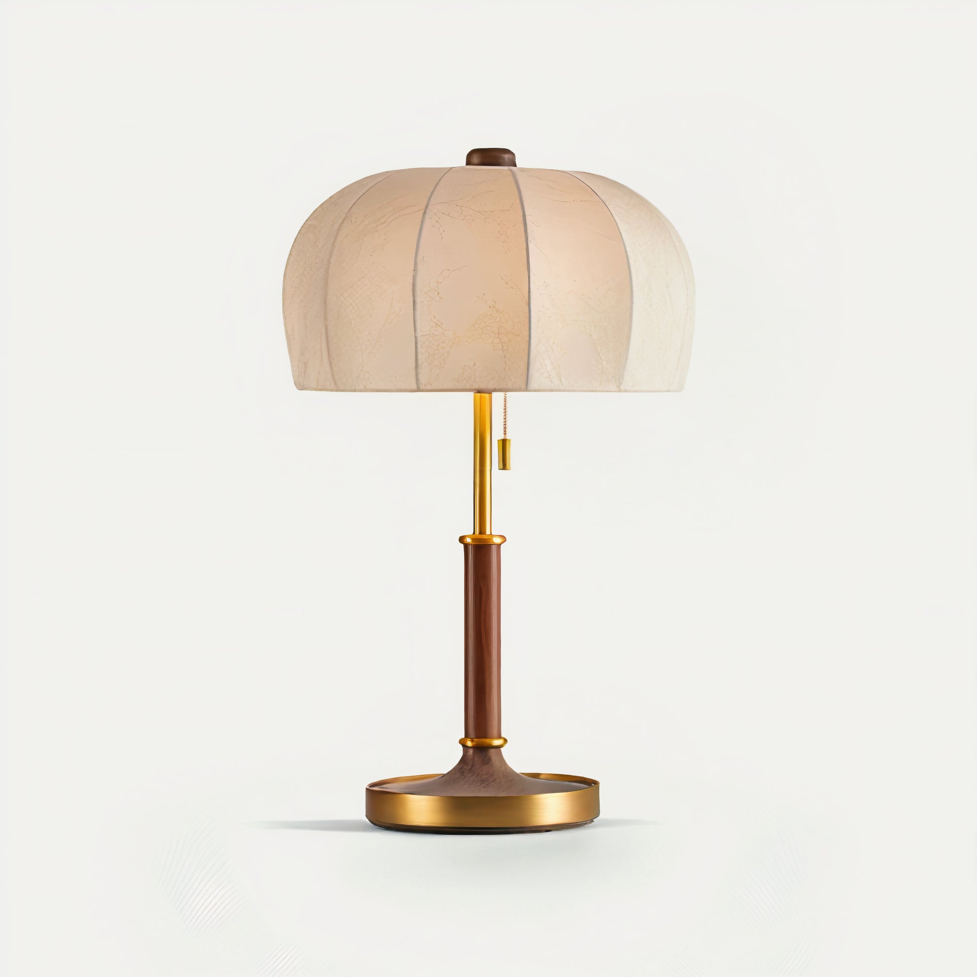 French vintage table lamp with a beige shade, wooden base, and brass accents on a light gray background